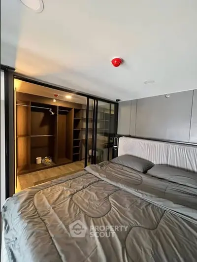 Modern bedroom with walk-in closet and sleek design