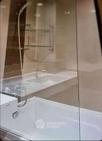 Modern bathroom with glass shower and sleek fixtures