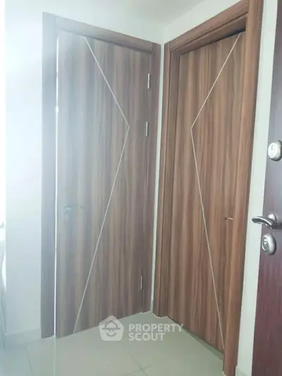 Modern interior with sleek wooden doors and glossy tiled flooring