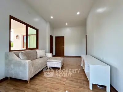 Spacious living room with modern sofa and wooden flooring