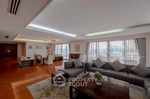 Spacious luxury living room with elegant decor and large windows offering stunning views.