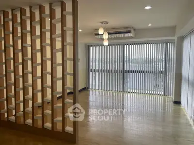 Spacious modern living room with wooden partition and large windows
