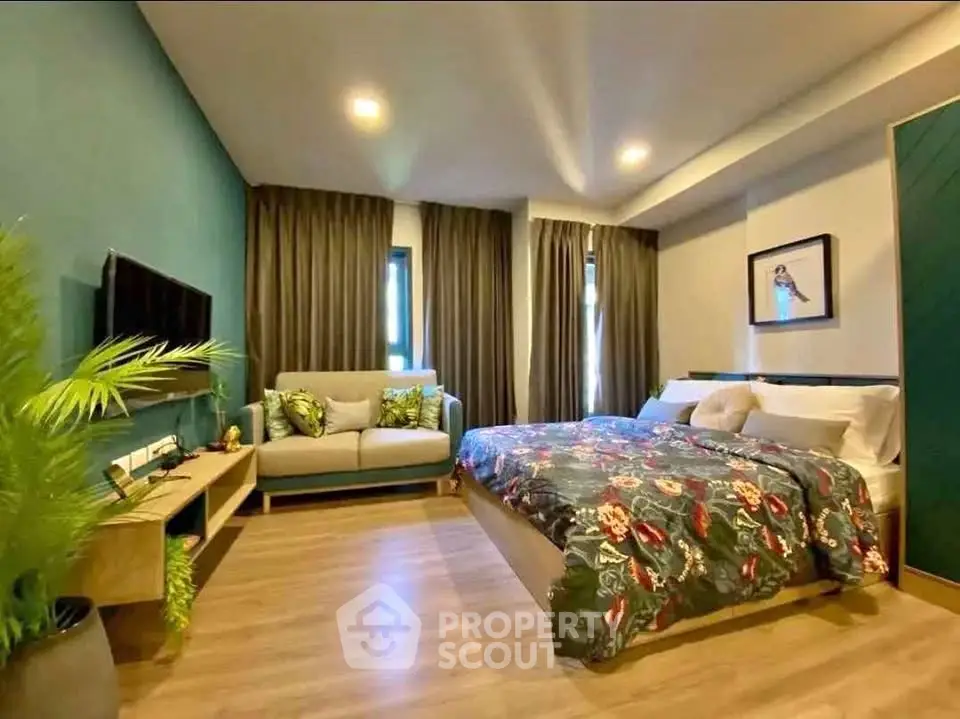 Modern bedroom with stylish decor, cozy seating area, and elegant lighting in a contemporary apartment.