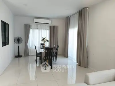 Spacious dining area with modern decor and natural light in a contemporary home.