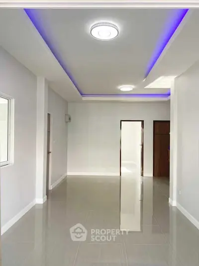 Spacious modern interior with sleek lighting and glossy tiled floors, perfect for customization.