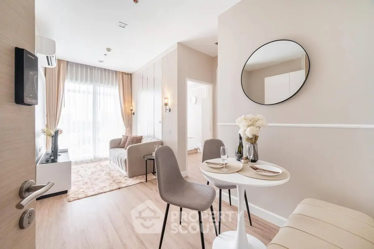 Modern living room with elegant decor and natural light, featuring a cozy dining area and stylish furnishings.