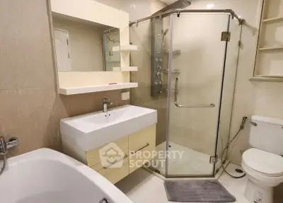 Modern bathroom with glass shower, bathtub, and sleek vanity in a contemporary home.