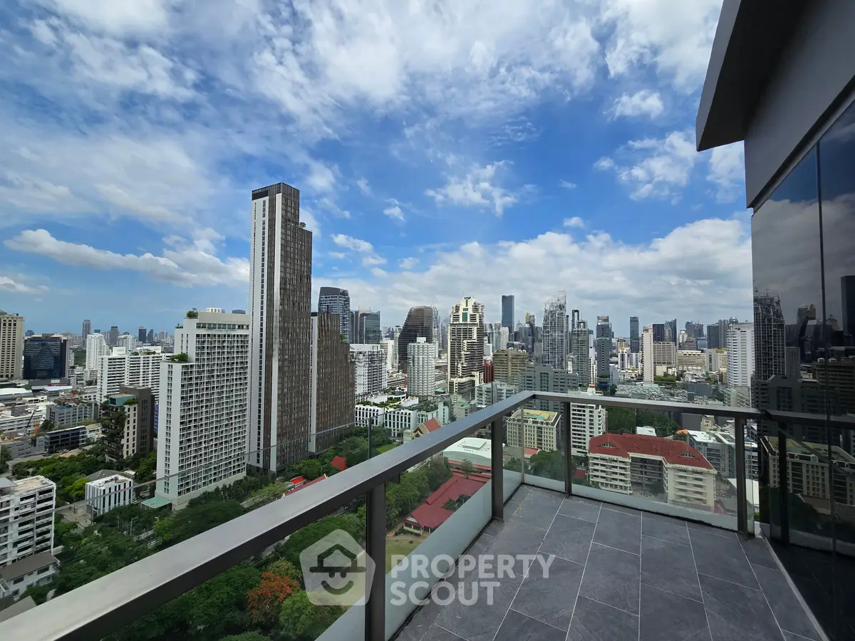 Stunning cityscape view from a modern high-rise balcony with glass railing and tiled flooring.