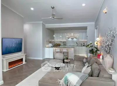 Stylish open-plan living room with modern kitchen and cozy fireplace