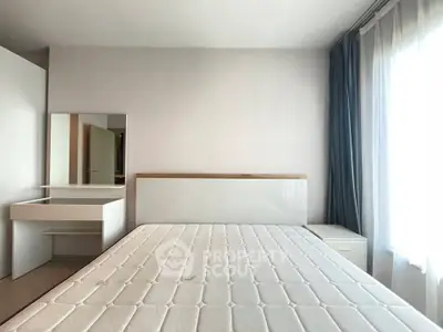 Spacious bedroom with natural light and modern furnishings