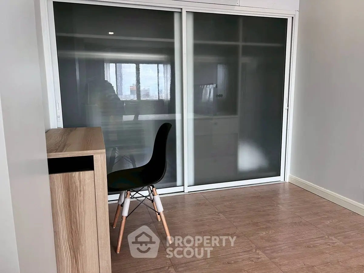 Modern study room with sleek sliding door wardrobe and stylish chair