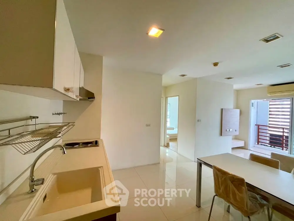 Modern open-layout kitchen and dining area with sleek design and natural light.