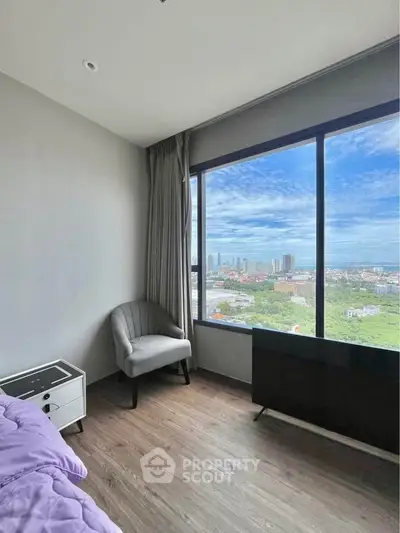 Modern bedroom with panoramic city view from large window