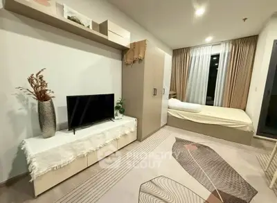 Modern bedroom with stylish decor, featuring a cozy bed, sleek TV stand, and elegant curtains.