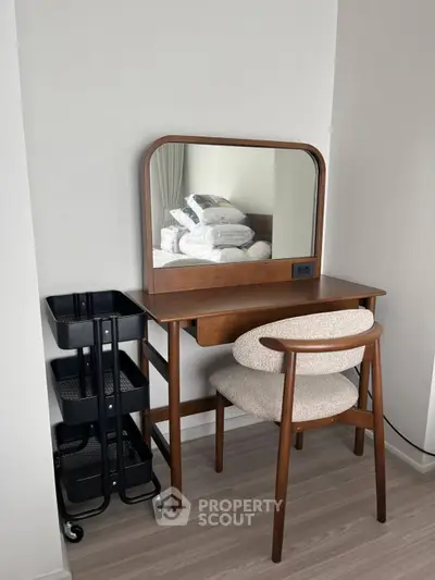 Stylish bedroom vanity with mirror and chair, perfect for modern interiors.