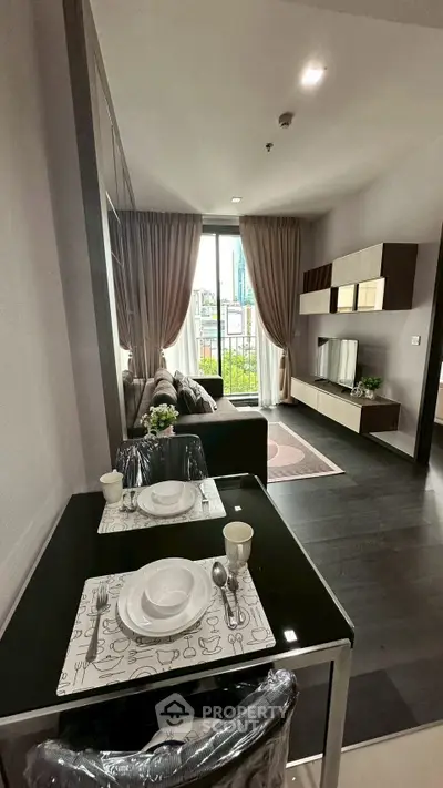 Modern living room with elegant decor and city view from balcony.