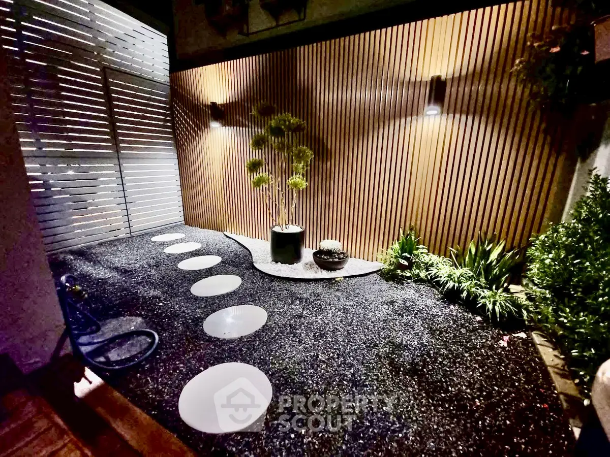 Charming modern garden with stylish lighting and stepping stones