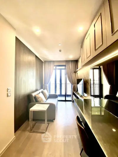 Modern living room with sleek design, large windows, and stylish furniture in a contemporary apartment.
