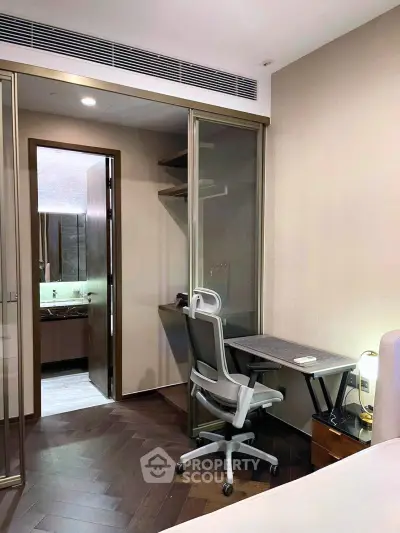 Modern bedroom with study area and ensuite bathroom in luxury apartment