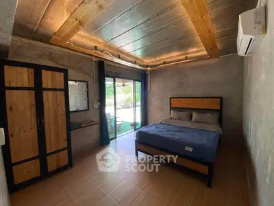 Modern industrial-style bedroom with wooden accents and large window view.