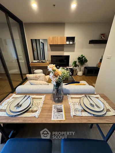 Modern living room with dining area featuring stylish decor and cozy ambiance.