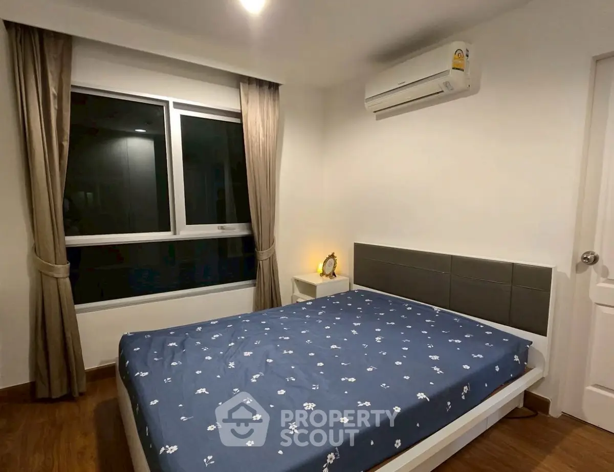 Cozy bedroom with modern decor and air conditioning in a stylish apartment.