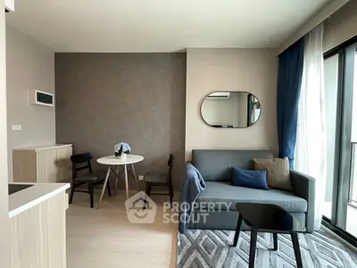 Modern living room with stylish decor and balcony access in a contemporary apartment.