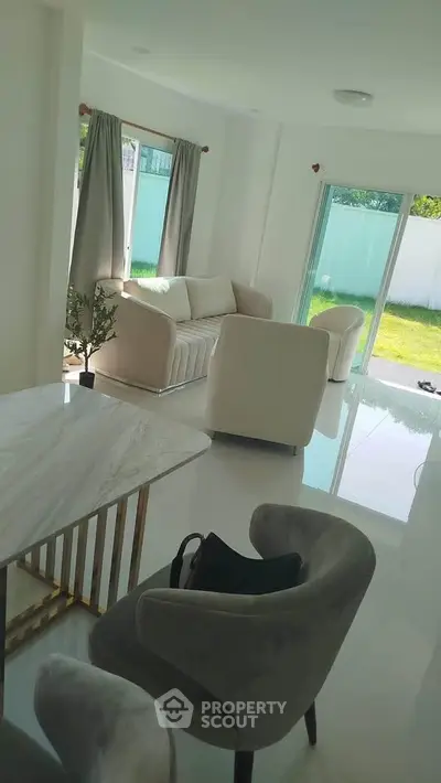 Bright modern living room with elegant furniture and garden view