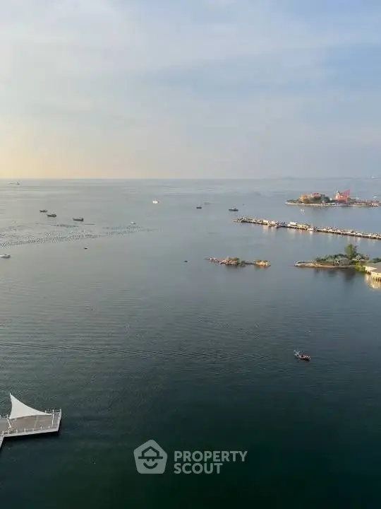 Stunning waterfront view with serene ocean and distant islands, perfect for tranquil living.