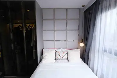 Modern bedroom with stylish decor and ample natural light