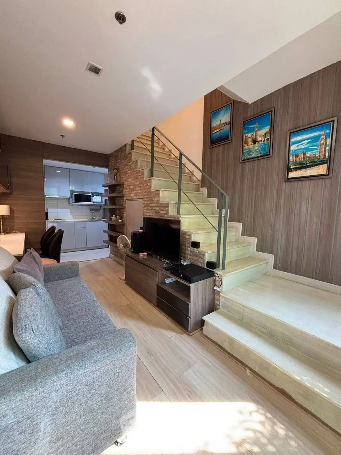 Modern living room with stylish staircase and cozy seating area