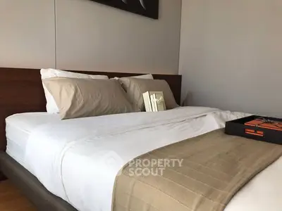 Cozy bedroom with elegant decor and plush bedding, perfect for relaxation and comfort.
