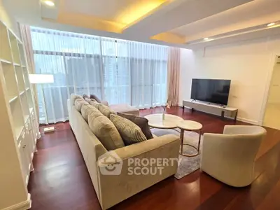 Spacious modern living room with large windows and elegant furnishings in a high-rise apartment.