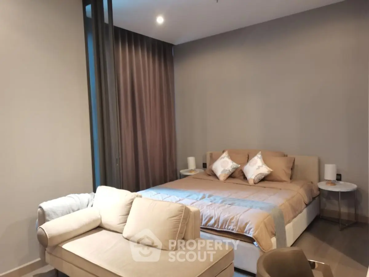 Modern bedroom with cozy seating area and stylish decor