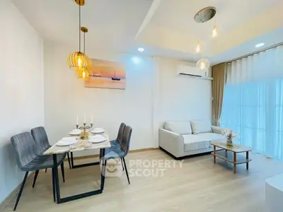 Modern living room with elegant dining area and cozy sofa, featuring stylish lighting and minimalist decor.