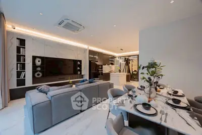 Luxurious open-plan living room with modern kitchen and elegant dining area, featuring sleek marble finishes.