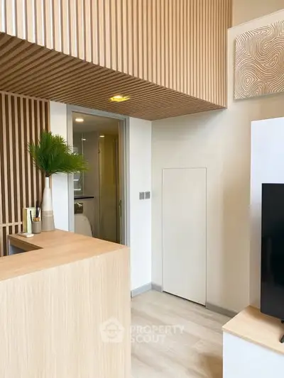 Modern interior with wooden accents and sleek design, featuring a stylish partition and contemporary decor.