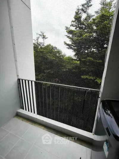 Charming balcony with lush green view, perfect for relaxation and enjoying nature.