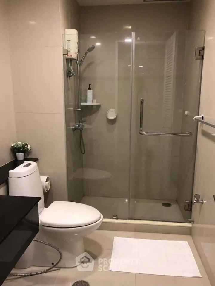 Modern bathroom with glass shower enclosure and sleek fixtures