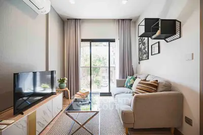 Modern living room with stylish decor and balcony view