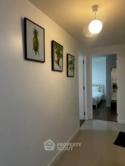 Bright hallway with modern decor leading to a cozy bedroom in a stylish apartment.