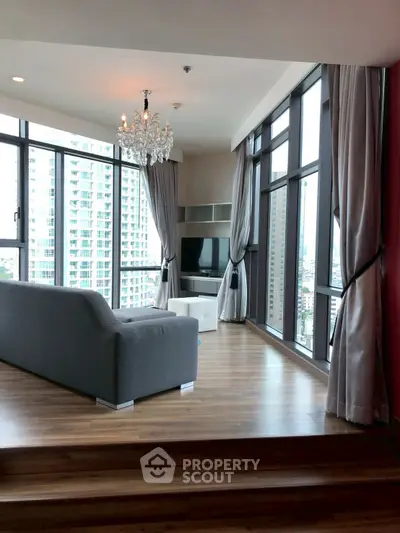 Luxurious corner unit living room with floor-to-ceiling windows and stunning city view.