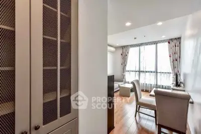 Elegant living room with natural light and stylish furniture, perfect for modern living.