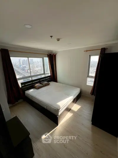 Spacious bedroom with city view and natural light in modern apartment