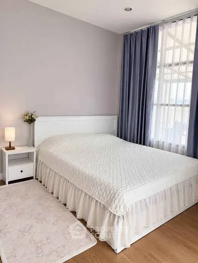 Cozy bedroom with elegant white bedding and soft lighting, perfect for relaxation and comfort.