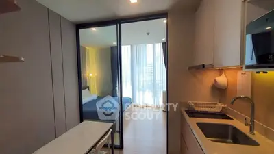 Modern studio apartment with sleek kitchen and cozy bedroom, perfect for urban living.