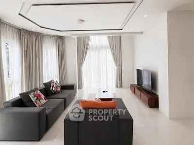 Spacious modern living room with elegant decor and large windows
