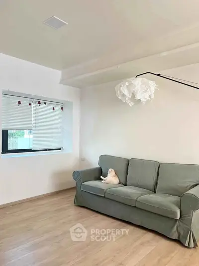 Cozy living room with modern sofa and stylish lighting, perfect for relaxation.