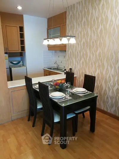 Charming dining area with modern kitchen, elegant lighting, and stylish decor for a cozy home ambiance.