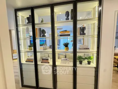 Stylish modern living room with illuminated display shelves and elegant decor
